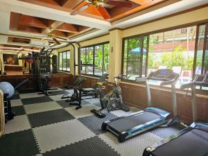 a gym with treadmills and exercise equipment in a room at Patong Central Hotel and Apartment in Patong Beach