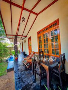 a dining room with a wooden table and chairs at Wild Horizon in Udawalawe