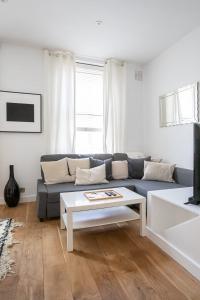 a living room with a blue couch and a coffee table at 1 Bedroom Baker Street Central Apartment in London