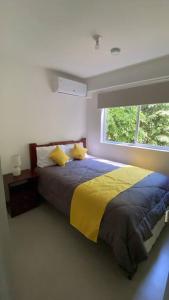 a bedroom with a large bed with a window at Apartamento hermoso Playa Blanca in Punta Leona