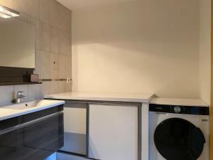 a kitchen with a sink and a washing machine at Appartement au pied des cols in Saint-Jean-de-Maurienne +6 photos