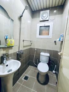 a bathroom with a toilet and a sink at Haven in Makkah