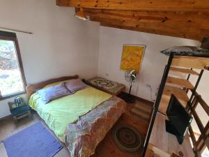 a small bedroom with a bed and a ladder at Casita Alegre in Cafayate