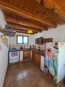 a kitchen with a refrigerator and a stove at Casita Alegre in Cafayate