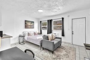 a bedroom with a bed and a couch and a table at Executive Studio Hollywood Blvd & Near Beach in Hollywood +34 photos