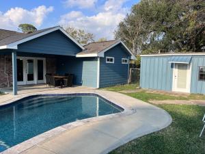 a house with a swimming pool in front of a house at Pool/ Outdoor kitchen/Pool table in Houston