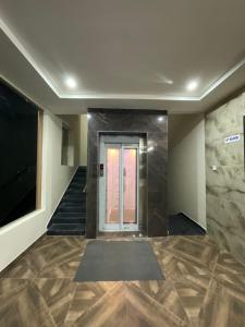 a hallway with a door and a staircase with a stair mat at MGR RESIDENCY in Srikalahasti