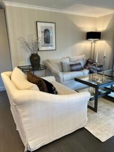 a living room with a white couch and a table at Appartement ALLURE Wohnen auf Zeit in Eschen