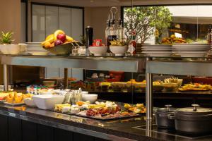 a buffet line with many plates of food on it at Hôtel Etoile Maillot in Paris
