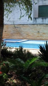 a swimming pool in front of a building at Casa de Praia - Maria Farinha in Paulista