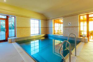 a large swimming pool in a house at Penzión UNA in Liptovský Ján