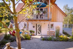 a house with a balcony and a patio at KrämersBug - Unterkunft für Familien mit kleinen Kindern in Simmershofen