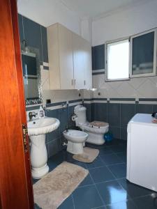 a bathroom with two toilets and a sink at Sunny villa Borakaj Vlora in Vlorë