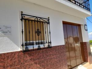 a iron gate on the side of a building at Casa Quico in Higuera de Arjona