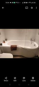 a picture of a bathroom with a tub and a toilet at Mill cottage in Carrickfergus