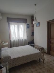 a bedroom with a bed and a window at B&B Il Cedro in Salve