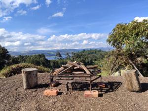 a pile of wood sitting on top of a hill at Cabaña Kandilejas in Guatavita