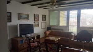 a living room with a couch and a television at Stan u Zenici in Zenica