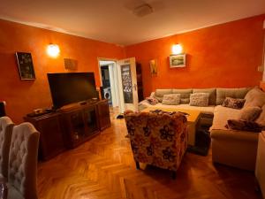 a living room with a couch and a tv at Apartman Sunnyplace in Mostar