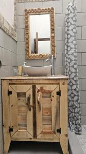 a bathroom with a sink and a mirror at Mano a Mano Eco Hostal in Las Peñitas