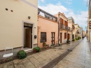 an empty street in an alley with buildings at La Dolce Cagliari holiday home in Cagliari