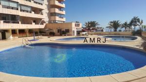 a large swimming pool in front of a building at APTO Acceso Directo Playa La Fossa Calpe in Calpe +58 photos