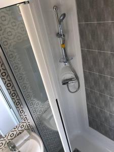 a bathroom with a shower and a sink at Immaculate 2020 Caravan on Newquay Holiday Park in Newquay