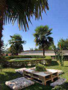 a park with a picnic table and palm trees at Sunny villa Borakaj Vlora in Vlorë