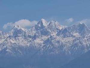 a snow covered mountain range with clouds in the sky at Hotel Gogreen Kattike Pvt. Ltd. in Nagarkot
