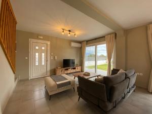 a living room with a couch and a chair at Taras Residence in Karavadhos