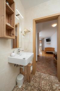 a bathroom with a sink and a toilet at Rooms & Apartments Pr Matjon in Bled