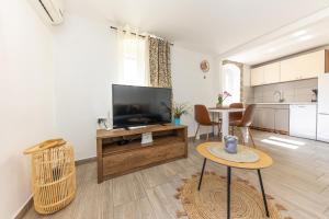 a living room with a television and a table at Romantic City View in Split