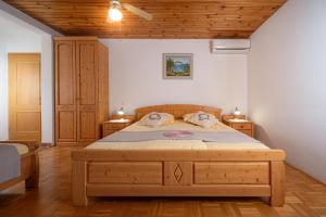 a bedroom with a large bed in a room at Rooms & Apartments Pr Matjon in Bled