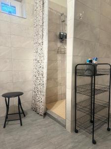 a shower with a table and a stool in a bathroom at Apartmán vo vidieckom dome in Malá Tŕňa