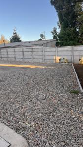 a fence on the side of a road at Pewma Apart Hotel in Chillán