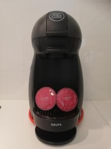 a black coffee maker with two red circles on it at Apartma Neža in Bled