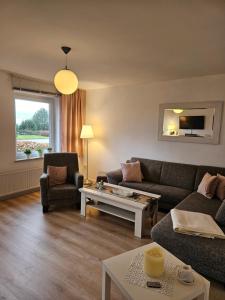 a living room with a couch and a table at Zollhaus 26 in Hohegeiß