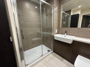a bathroom with a shower and a sink at New built apartment in Hendon