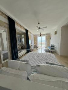 a large bedroom with a bed and a ceiling fan at Dar Daniella - Small Design Luxury Hotel in Tabarka