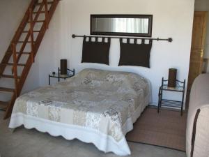 a bedroom with a bed in a room with stairs at Chambre d'hôtes "La Bastide des Eucalyptus" in Antibes