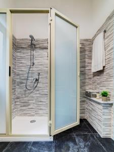 a shower with a glass door in a bathroom at Sea Shell in Riposto