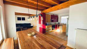 a living room and kitchen with a wooden table at Haus-no19 GbR in Kippenheim