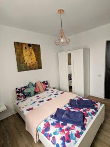 a bedroom with two beds and a painting on the wall at Old town apartment in Bucharest