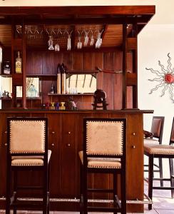 a bar with two chairs and a mirror at Luna Waves in Negombo