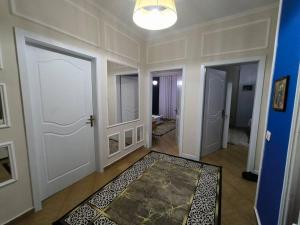 a hallway with two doors and a rug on the floor at Elbasan view point in Elbasan