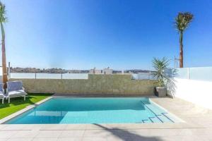 a swimming pool in the backyard of a house at Casa Eden luxury villa in Rojales in Rojales