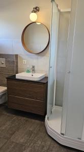 a bathroom with a sink and a mirror at Kviholmi Premium Apartments in Hvolsvöllur