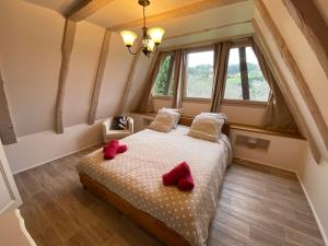 a bedroom with a bed with red slippers on it at Gite Introvigne Sarlat in Sarlat-la-Canéda