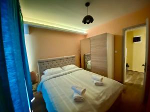 a bedroom with a bed with two towels on it at Danka Apartment in Thessaloniki