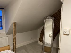 a bathroom with a mirror in a attic at Stunning 1-Bed Studio in Windsor in Windsor
